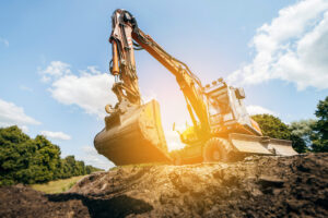 Earth excavator machine working by the roadside. Road service repairs the highway