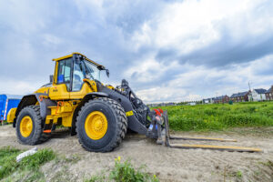 Volvo L70H wheel loader machine on a construction site in the city of Kampen during an overcast spring day.